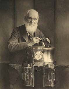 Thomson, resting on a binnacle and holding a marine azimuth mirror.